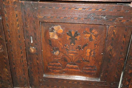 A 17th century marquetry inlaid oak court cabinet W.127cm